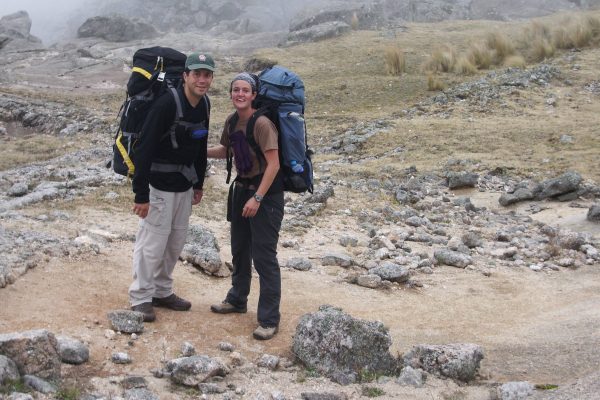 A male and female hiker trekking with large packs