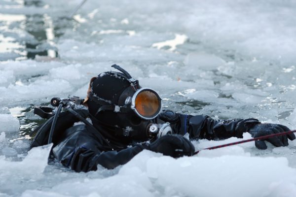 A scuba diver resurfaces in Antarctica amidst the brash ice
