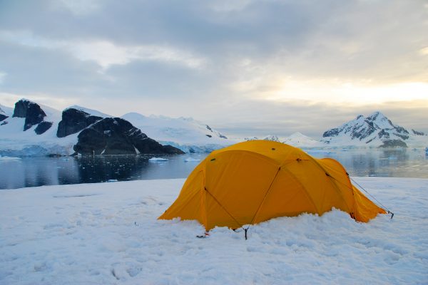 A bright yellow tent pitched in the snow in Antarctica