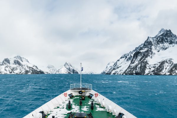 Sailing through wind-whipped and dramatic Antarctic scenery